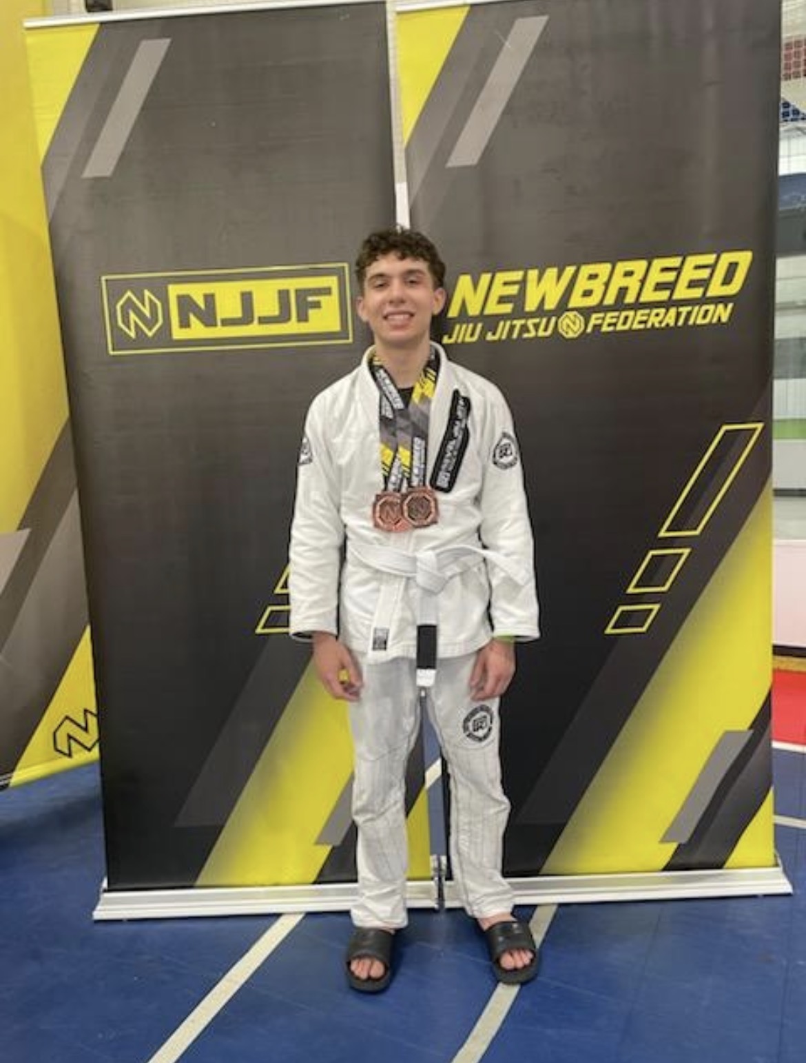 Nicholas Mattos with Jiu Jitsu tournament medals